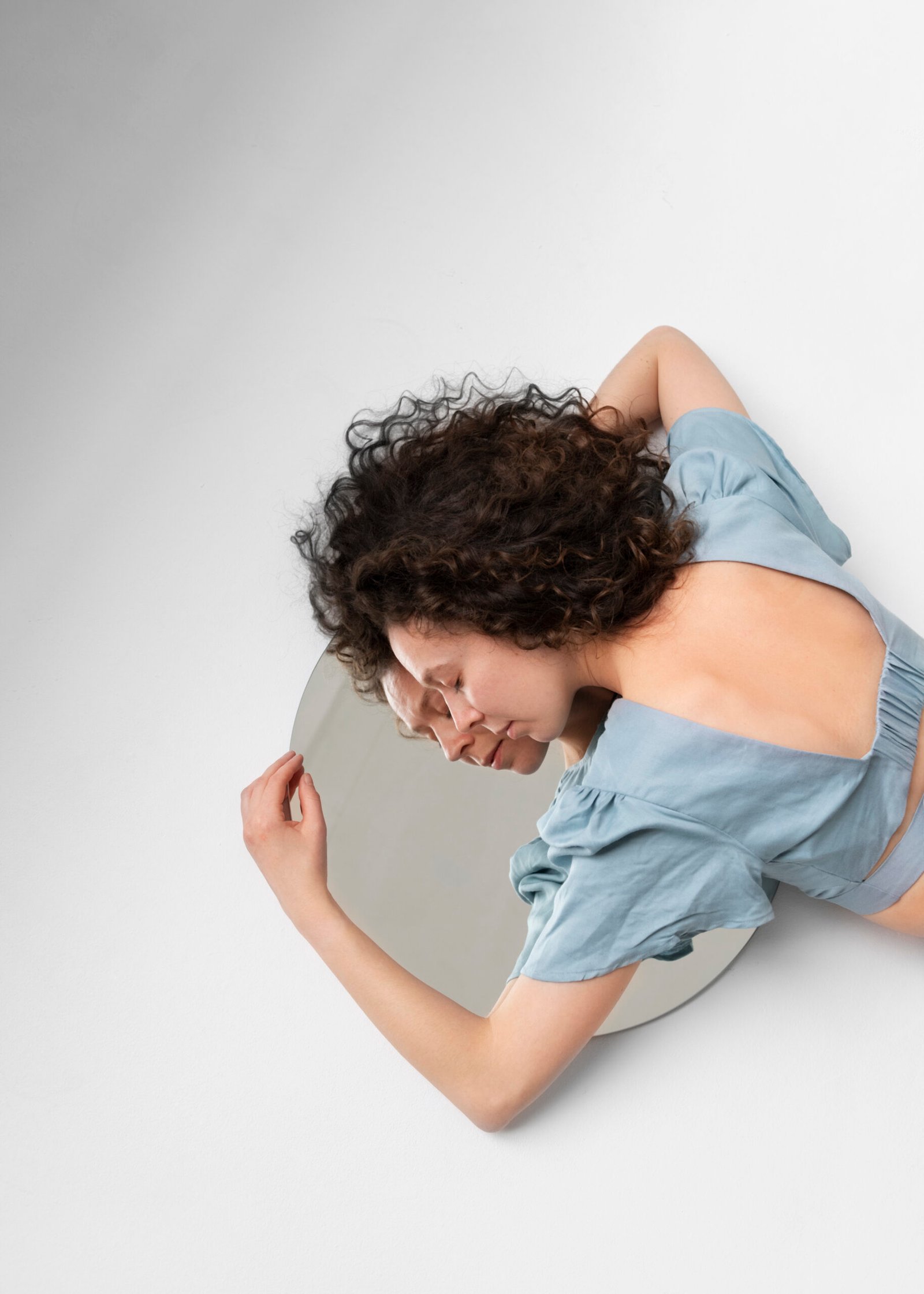 high angle woman laying mirror